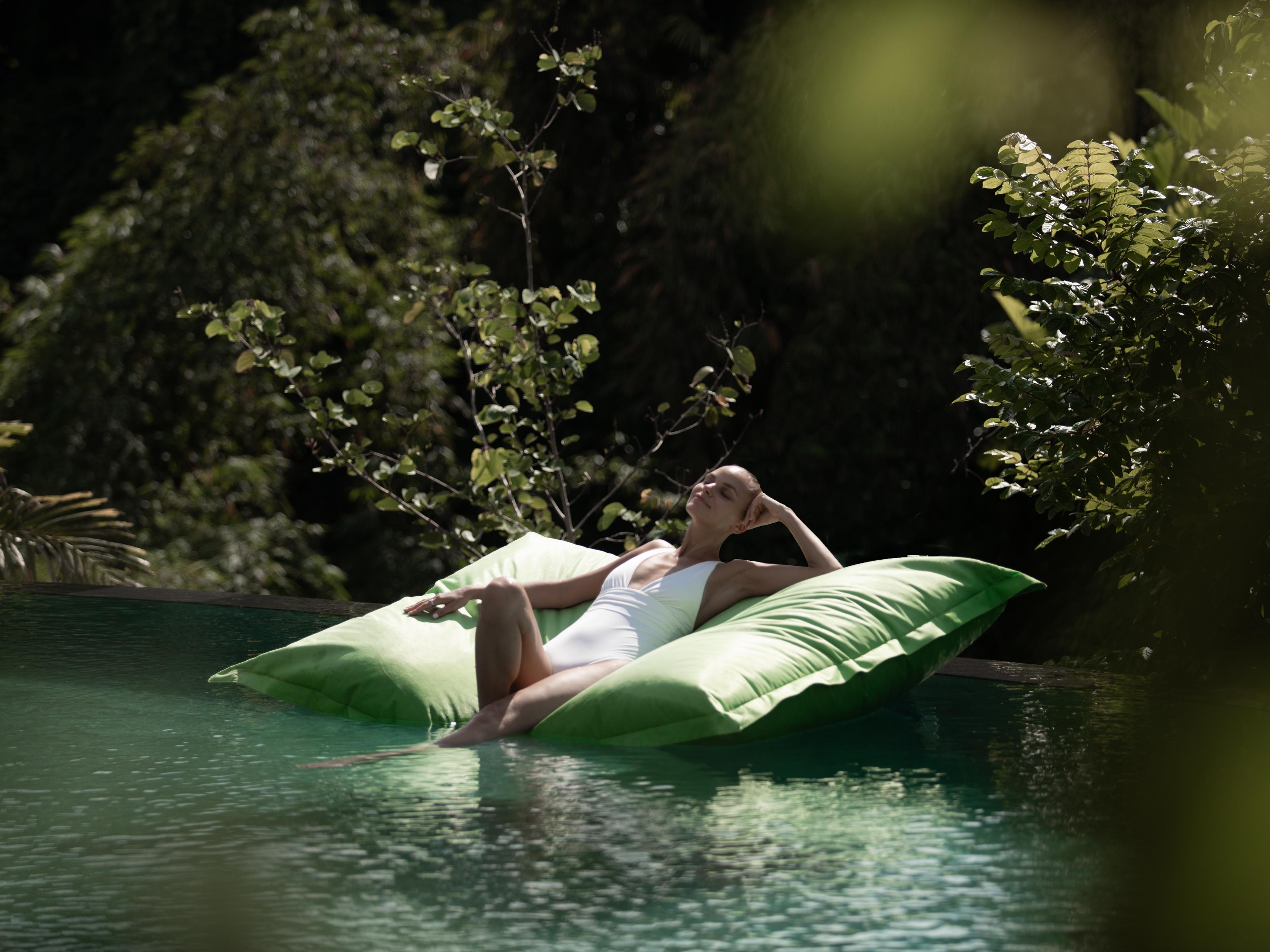 Adiwana Suweta Hotel Ubud Eksteriør billede A woman relaxing on a floating bag